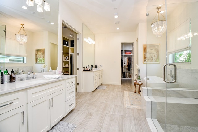 802 W 30th St, Houston, TX 77018 - bathroom with vanity, a walk in closet, a soaking tub, and a shower stall