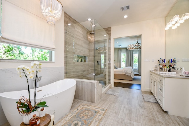 802 W 30th St, Houston, TX 77018 - full bath with plenty of natural light, vanity, a shower stall, a freestanding tub, and recessed lighting