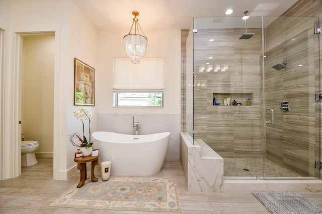 802 W 30th St, Houston, TX 77018 - bathroom with a stall shower, a freestanding tub, toilet, and baseboards