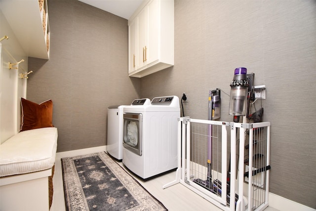 802 W 30th St, Houston, TX 77018 - washroom featuring cabinet space, independent washer and dryer, and light wood-style floors