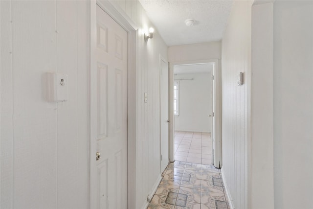 7547 Touchstone St, Houston, TX 77028 - corridor featuring light tile patterned floors and a textured ceiling