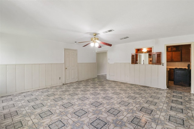 7547 Touchstone St, Houston, TX 77028 - unfurnished living room featuring a wainscoted wall and ceiling fan