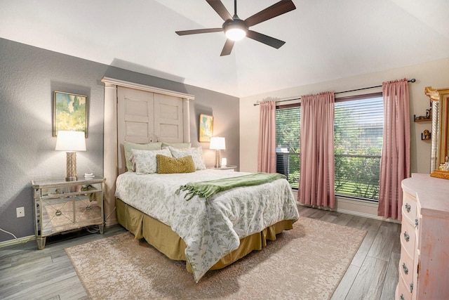 2909 Landing Edge Ln, Dickinson, TX 77539 - bedroom featuring light wood finished floors, high vaulted ceiling, a ceiling fan, and baseboards
