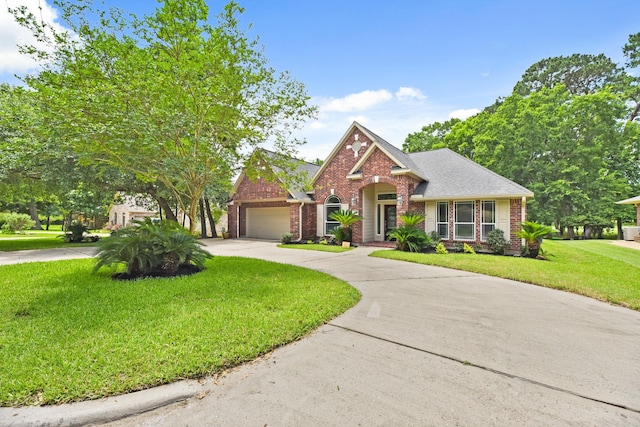 512 Cherry Hills Dr, Huntsville, TX 77340 - view of front of home featuring brick siding, an attached garage, curved driveway, and a front yard