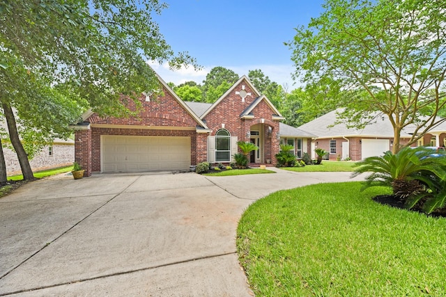 512 Cherry Hills Dr, Huntsville, TX 77340 - traditional-style house with an attached garage, driveway, brick siding, and a front yard