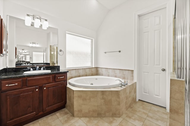 512 Cherry Hills Dr, Huntsville, TX 77340 - bathroom with a jetted tub, vanity, tile patterned floors, and vaulted ceiling