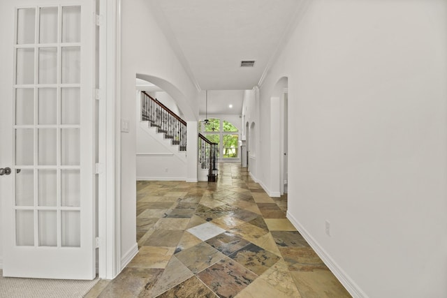 512 Cherry Hills Dr, Huntsville, TX 77340 - foyer entrance with stone tile floors, arched walkways, stairway, baseboards, and ornamental molding