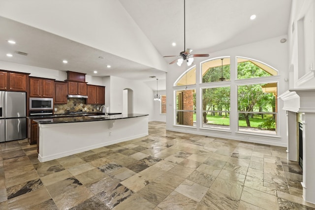 512 Cherry Hills Dr, Huntsville, TX 77340 - kitchen featuring appliances with stainless steel finishes, dark countertops, stone tile flooring, ceiling fan, and recessed lighting