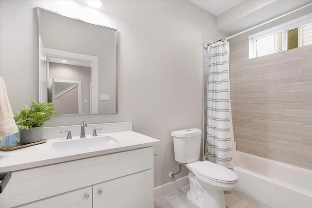 8307 Brecha Ln, Houston, TX 77055 - full bathroom featuring toilet, vanity, shower / tub combo with curtain, and baseboards