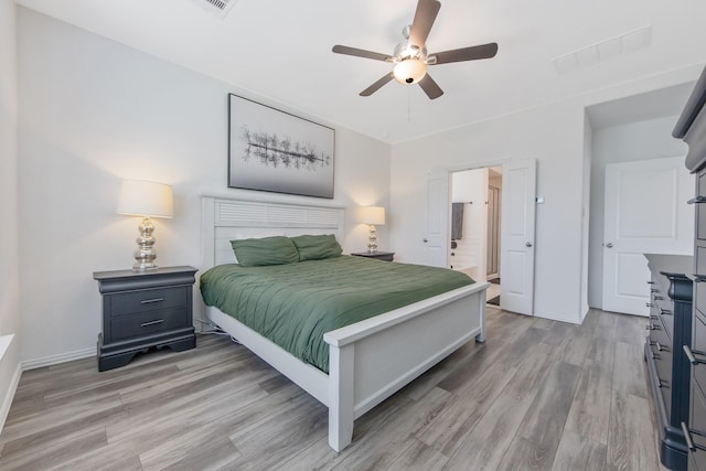 15511 Bosque Valley Ct, Cypress, TX 77433 - bedroom with light wood-style floors, baseboards, a ceiling fan, and ensuite bath