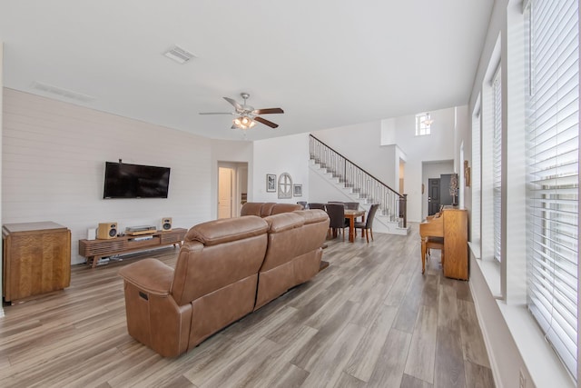 15511 Bosque Valley Ct, Cypress, TX 77433 - living room with stairs, light wood-style flooring, plenty of natural light, and a ceiling fan