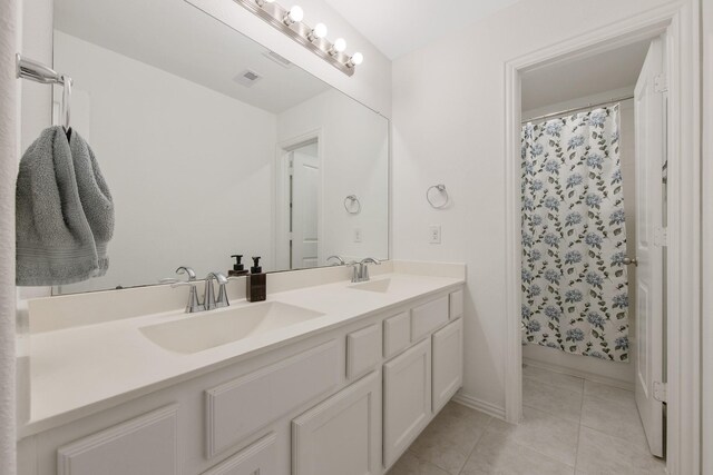 15511 Bosque Valley Ct, Cypress, TX 77433 - full bath featuring double vanity, tile patterned floors, curtained shower, and baseboards
