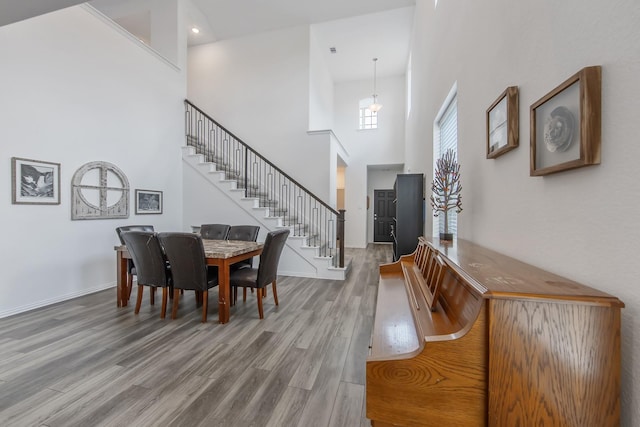 15511 Bosque Valley Ct, Cypress, TX 77433 - dining area with a high ceiling, stairway, wood finished floors, and baseboards
