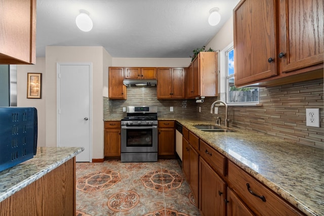 16338 N Glade, Houston, TX 77073 - kitchen featuring stainless steel range with gas cooktop, a sink, under cabinet range hood, brown cabinets, and tasteful backsplash