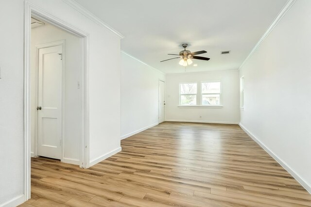 1502 W 9th St, Freeport, TX 77541 - empty room featuring crown molding, light wood-type flooring, ceiling fan, and baseboards