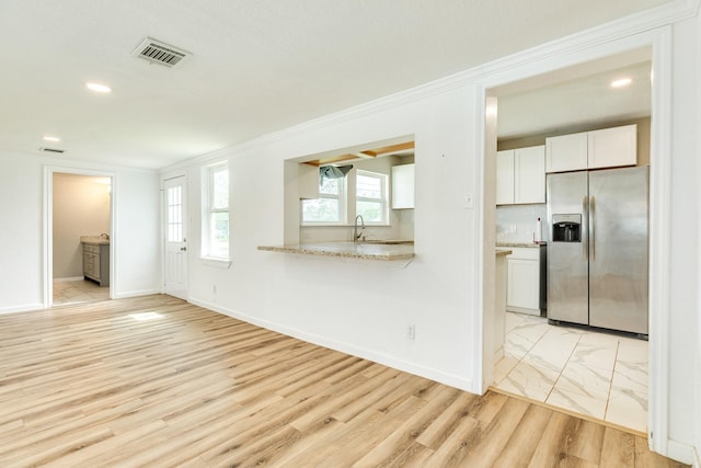 1502 W 9th St, Freeport, TX 77541 - unfurnished living room with a sink, light wood-style floors, baseboards, recessed lighting, and crown molding