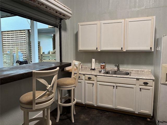 943 Sand Dune Dr, Crystal Beach, TX 77650 - bar with a sink and freestanding refrigerator