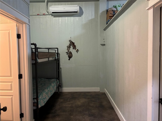 943 Sand Dune Dr, Crystal Beach, TX 77650 - bedroom with a wall mounted air conditioner, concrete floors, and baseboards