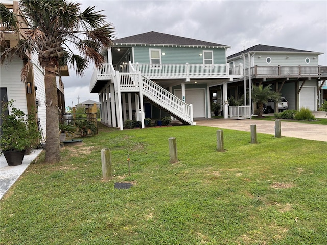 943 Sand Dune Dr, Crystal Beach, TX 77650 - back of house with a garage, driveway, a yard, a deck, and a shingled roof