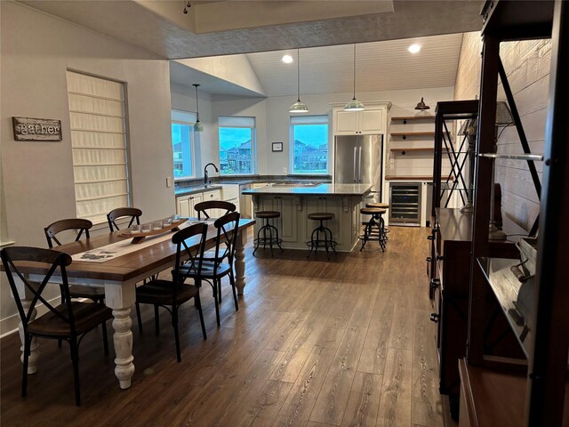 943 Sand Dune Dr, Crystal Beach, TX 77650 - dining space featuring dark wood-style flooring, wine cooler, and vaulted ceiling