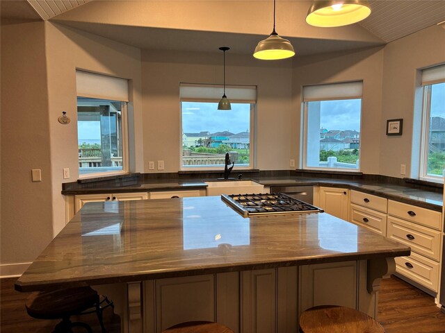 943 Sand Dune Dr, Crystal Beach, TX 77650 - kitchen featuring a sink, vaulted ceiling, dark wood finished floors, a center island, and stainless steel gas stovetop