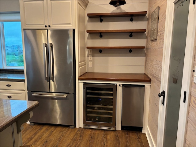 943 Sand Dune Dr, Crystal Beach, TX 77650 - kitchen featuring freestanding refrigerator, beverage cooler, dark countertops, and dark wood-style flooring