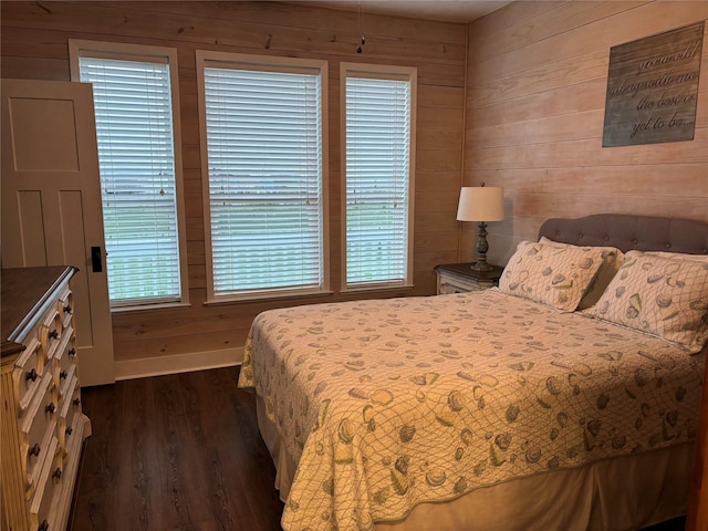 943 Sand Dune Dr, Crystal Beach, TX 77650 - bedroom with wooden walls and dark wood-style flooring