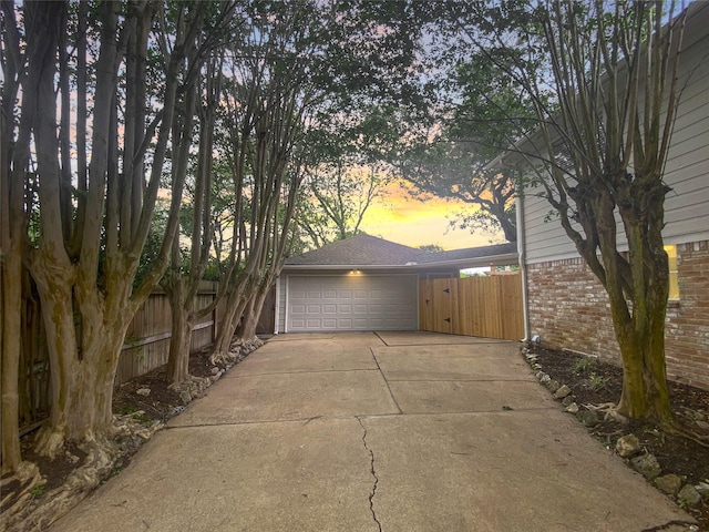 1927 Willowlake Dr, Houston, TX 77077 - garage at dusk with concrete driveway