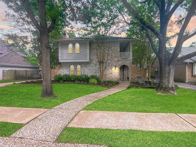 1927 Willowlake Dr, Houston, TX 77077 - view of front of house featuring brick siding, a chimney, and a balcony