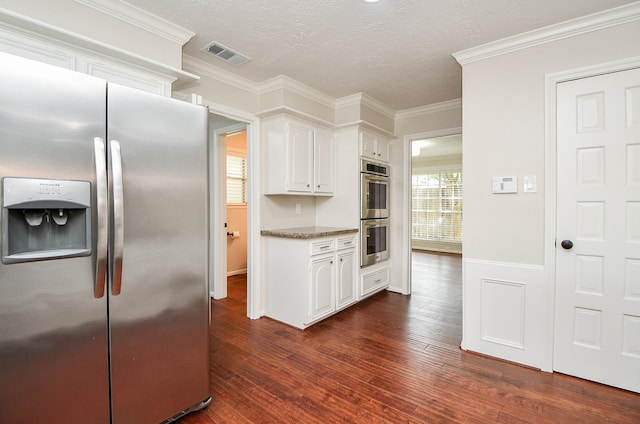 1927 Willowlake Dr, Houston, TX 77077 - kitchen with stainless steel appliances, dark wood-style floors, white cabinetry, a textured ceiling, and crown molding