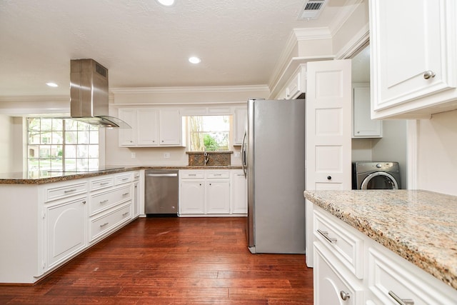 1927 Willowlake Dr, Houston, TX 77077 - kitchen with stainless steel appliances, washer / dryer, a sink, crown molding, and a peninsula