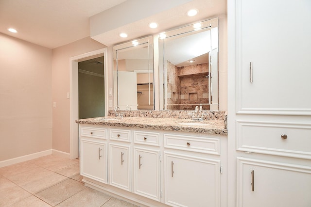 1927 Willowlake Dr, Houston, TX 77077 - bathroom featuring double vanity, tile patterned floors, baseboards, and recessed lighting