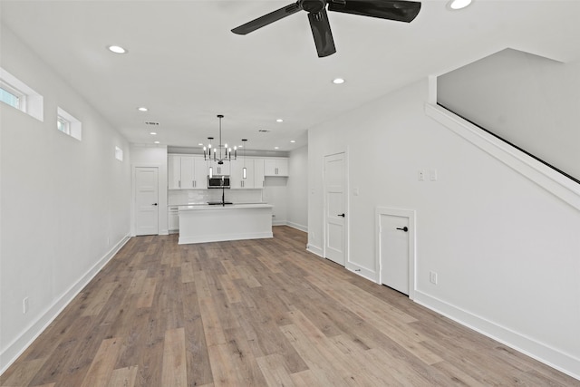 8417 Venus St Unit A B, Houston, TX 77088 - unfurnished living room featuring recessed lighting, light wood-style floors, baseboards, a chandelier, and a ceiling fan