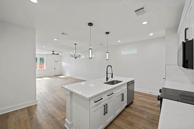 8417 Venus St Unit A B, Houston, TX 77088 - kitchen with stainless steel dishwasher, a sink, ceiling fan, baseboards, and white cabinets