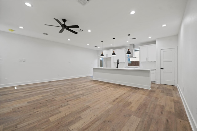 8417 Venus St Unit A B, Houston, TX 77088 - unfurnished living room with light wood-style flooring, a ceiling fan, recessed lighting, a sink, and baseboards