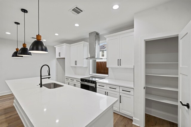 8417 Venus St Unit A B, Houston, TX 77088 - kitchen with electric range oven, ventilation hood, a sink, an island with sink, and white cabinetry