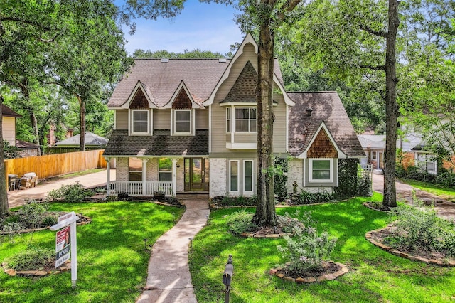 12906 Ivyforest Dr, Cypress, TX 77429 - view of front facade with covered porch, a shingled roof, and brick siding