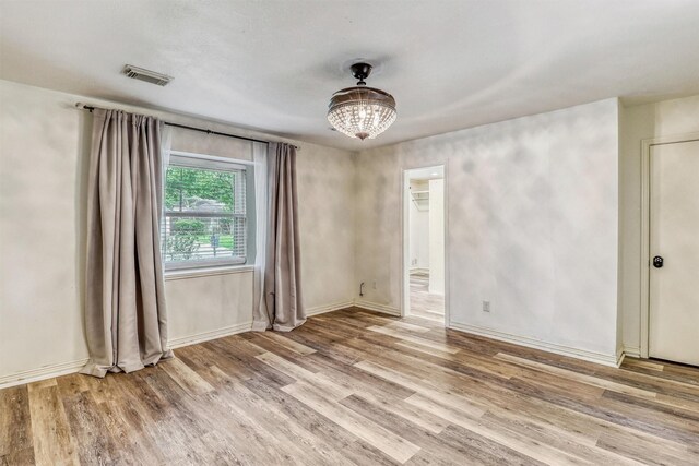 12906 Ivyforest Dr, Cypress, TX 77429 - spare room featuring light wood-style flooring and a chandelier