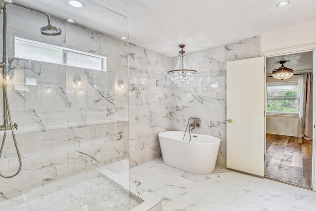 12906 Ivyforest Dr, Cypress, TX 77429 - full bath featuring a freestanding tub, a marble finish shower, recessed lighting, tile walls, and marble finish flooring