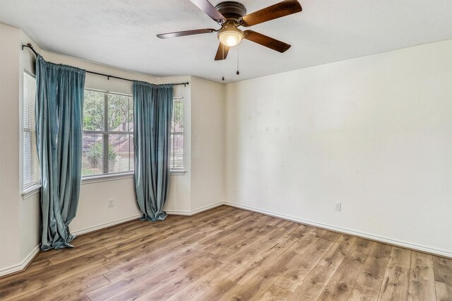 12906 Ivyforest Dr, Cypress, TX 77429 - empty room with wood finished floors and a ceiling fan
