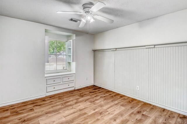 12906 Ivyforest Dr, Cypress, TX 77429 - spare room featuring light wood-style flooring, ceiling fan, and a textured ceiling