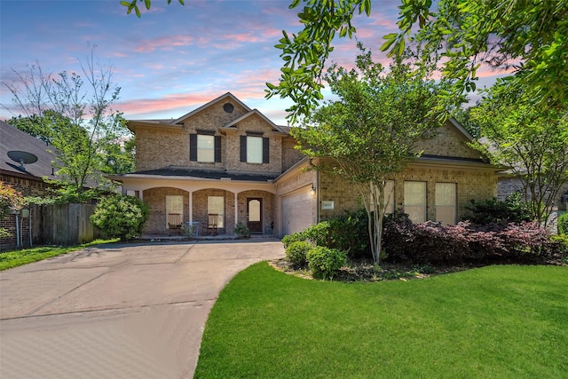 14619 Hampton Green Ln, Houston, TX 77044 - traditional-style home featuring concrete driveway, brick siding, an attached garage, and covered porch