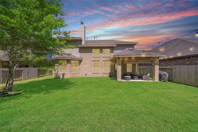 14619 Hampton Green Ln, Houston, TX 77044 - rear view of property featuring an outdoor living space, a chimney, a patio area, brick siding, and roof with shingles