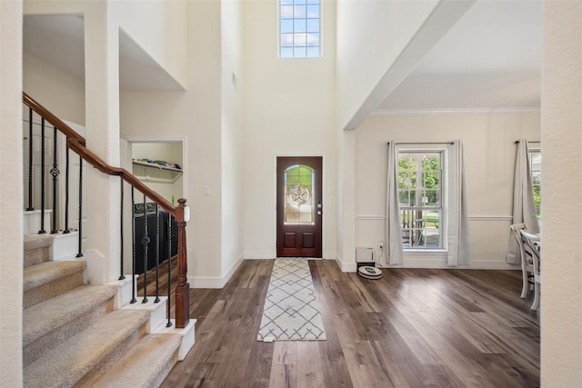 14619 Hampton Green Ln, Houston, TX 77044 - foyer featuring dark wood-type flooring, stairway, baseboards, ornamental molding, and a towering ceiling