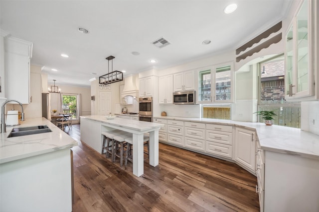 14619 Hampton Green Ln, Houston, TX 77044 - kitchen featuring a sink, stainless steel appliances, ornamental molding, white cabinets, and dark wood-type flooring