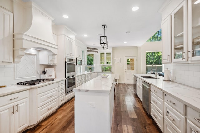 14619 Hampton Green Ln, Houston, TX 77044 - kitchen with stainless steel appliances, a sink, a peninsula, backsplash, and dark wood-style floors