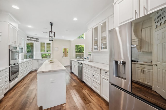 14619 Hampton Green Ln, Houston, TX 77044 - kitchen with appliances with stainless steel finishes, a kitchen island, backsplash, a peninsula, and recessed lighting