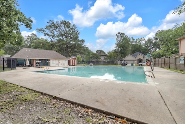 18389 Ten Oaks Ct, Porter, TX 77365 - community pool with a patio area, an outdoor structure, and view of scattered trees
