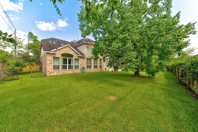 4815 N Pine Brook Way, Houston, TX 77059 - rear view of property with a fenced backyard and brick siding