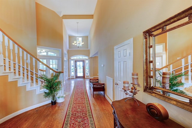 4815 N Pine Brook Way, Houston, TX 77059 - entrance foyer with a high ceiling, stairway, wood finished floors, and a chandelier